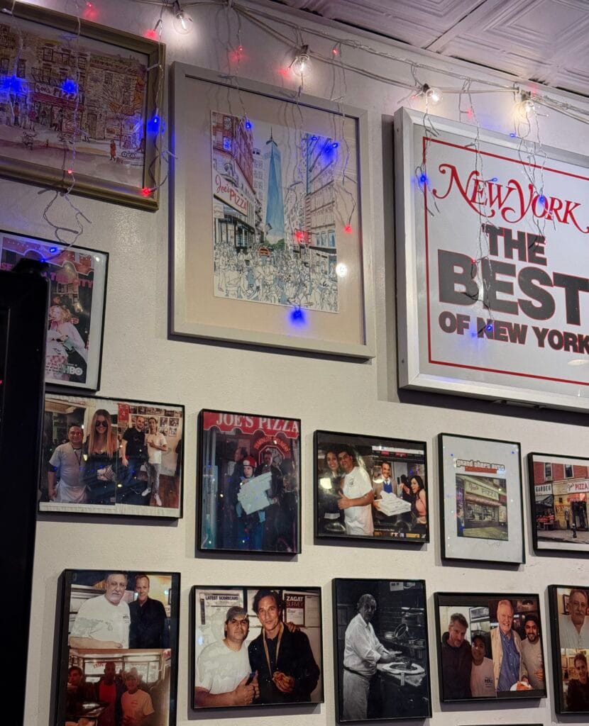 Pictures on wall of various celebrities that have gone to Joe's Pizza
