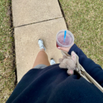 Walking with to go cup of tea with tote bag