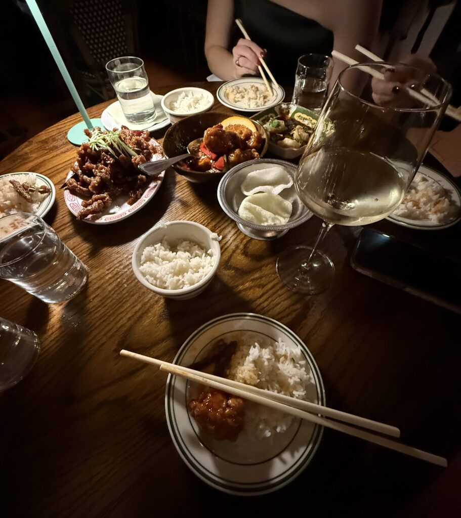 Family style spread of Chinese food. Several bowls of various entrees. 